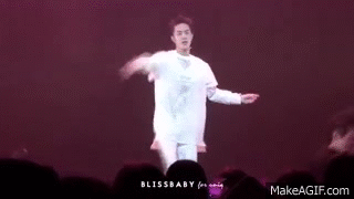 Wang Yibo dancing on stage with a seductive twirl.